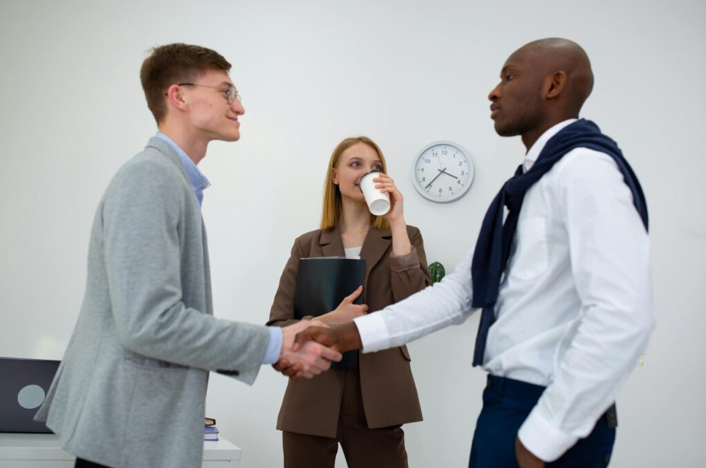 how to sell a service - handshaking after meeting